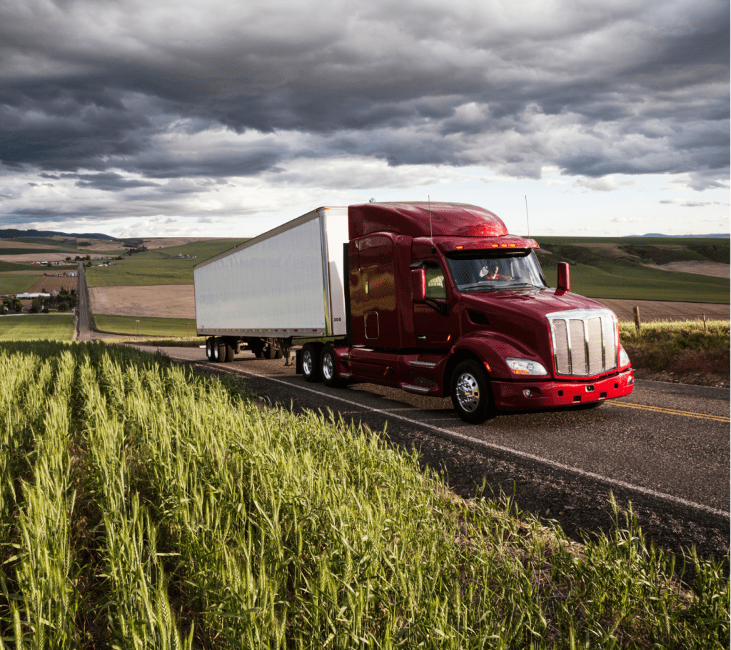 Transport truck driving through a winding country side. Transport truck driving through a winding country side.