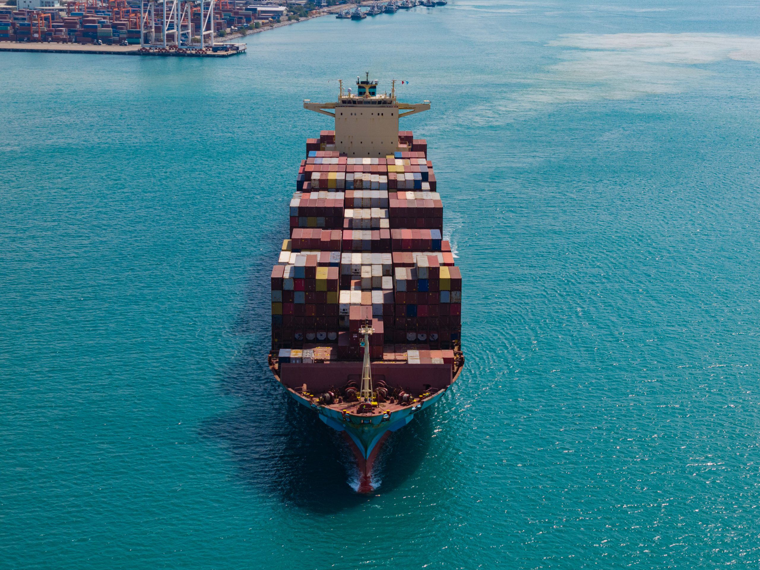 Large cargo ship transporting colorful containers across ocean