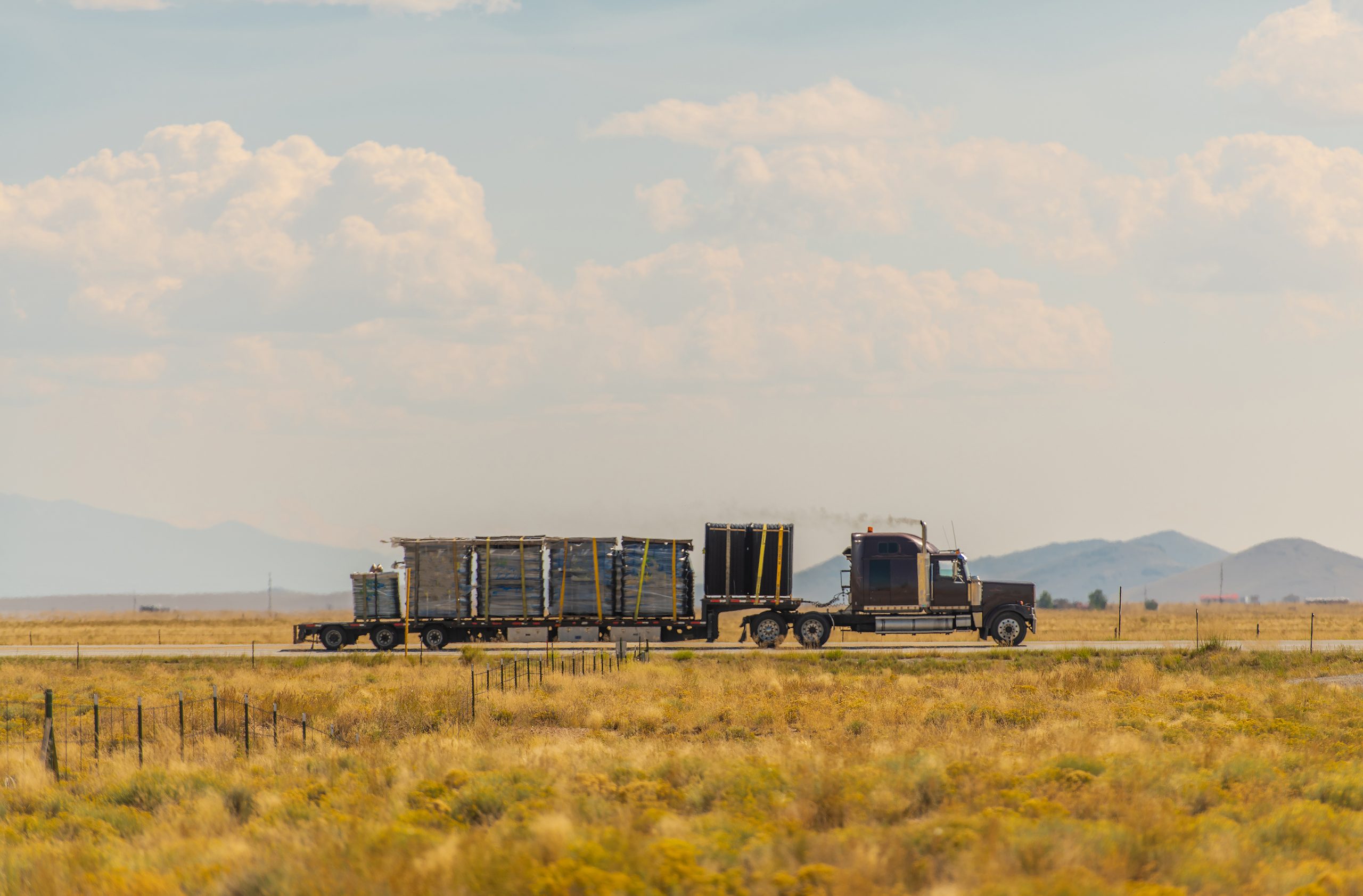 Heavy Loaded Semi Truck on a Highway Crossing Colorado Valley. Semi Truck on a Highway Crossing Colorado Valley