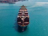 Large cargo ship transporting colorful containers in ocean, representing reliable ocean freight solutions for global shipping by Smith Transport Solutions.