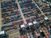 Aerial view of Kwai Tsing container terminals in Hong Kong, showcasing numerous shipping containers arranged in rows, emphasizing global logistics and ocean freight operations.